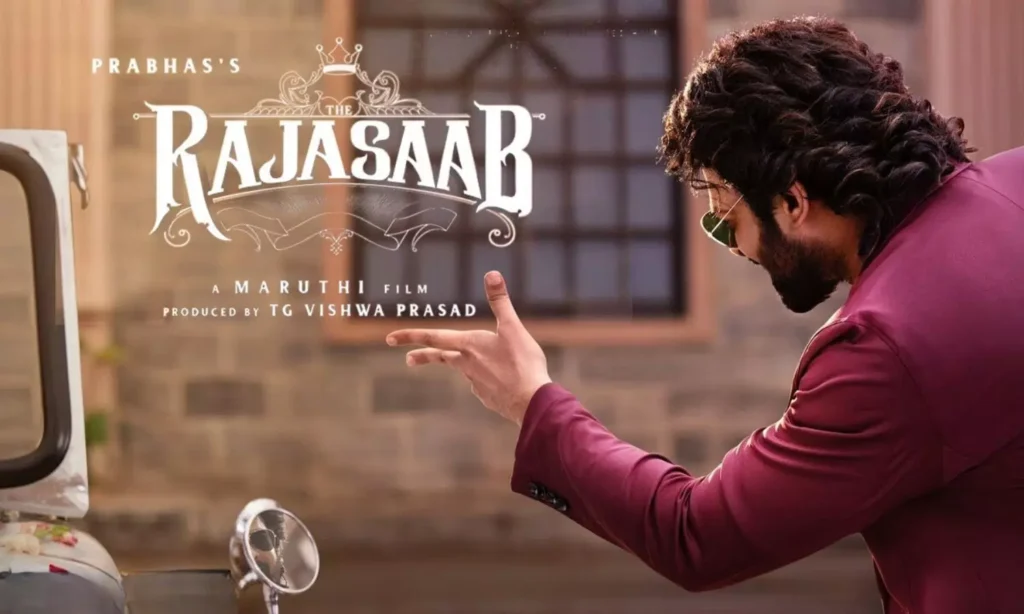 A man in a maroon suit gestures beside the Rajasaab film title graphic.