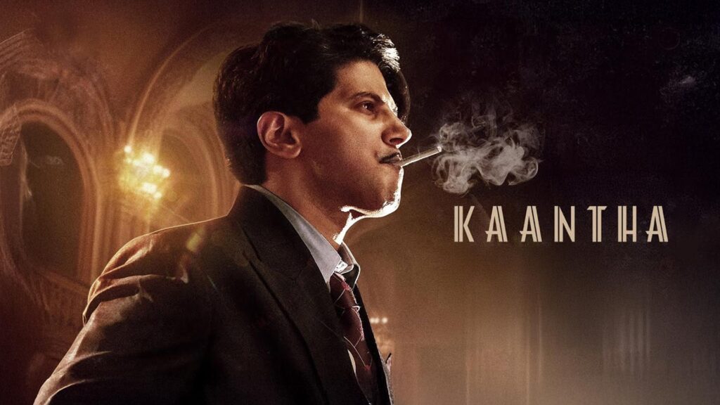 Man in a dark suit smoking beside the title Kaantha.