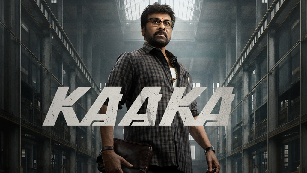 Man in glasses stands in a dark corridor behind the title “KAAKA.”