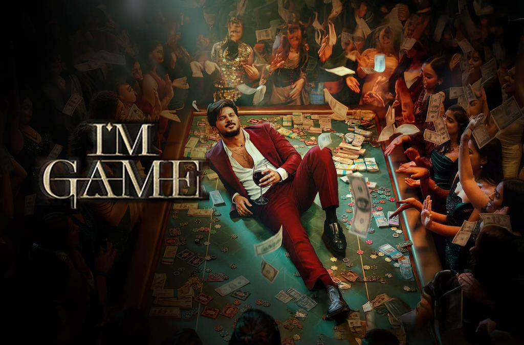 Man in a red suit sits on a casino table surrounded by money and a crowd, beneath “I’M GAME” lettering.