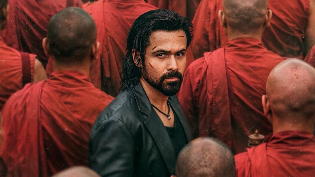 Bearded man in a black jacket surrounded by people wearing red robes.